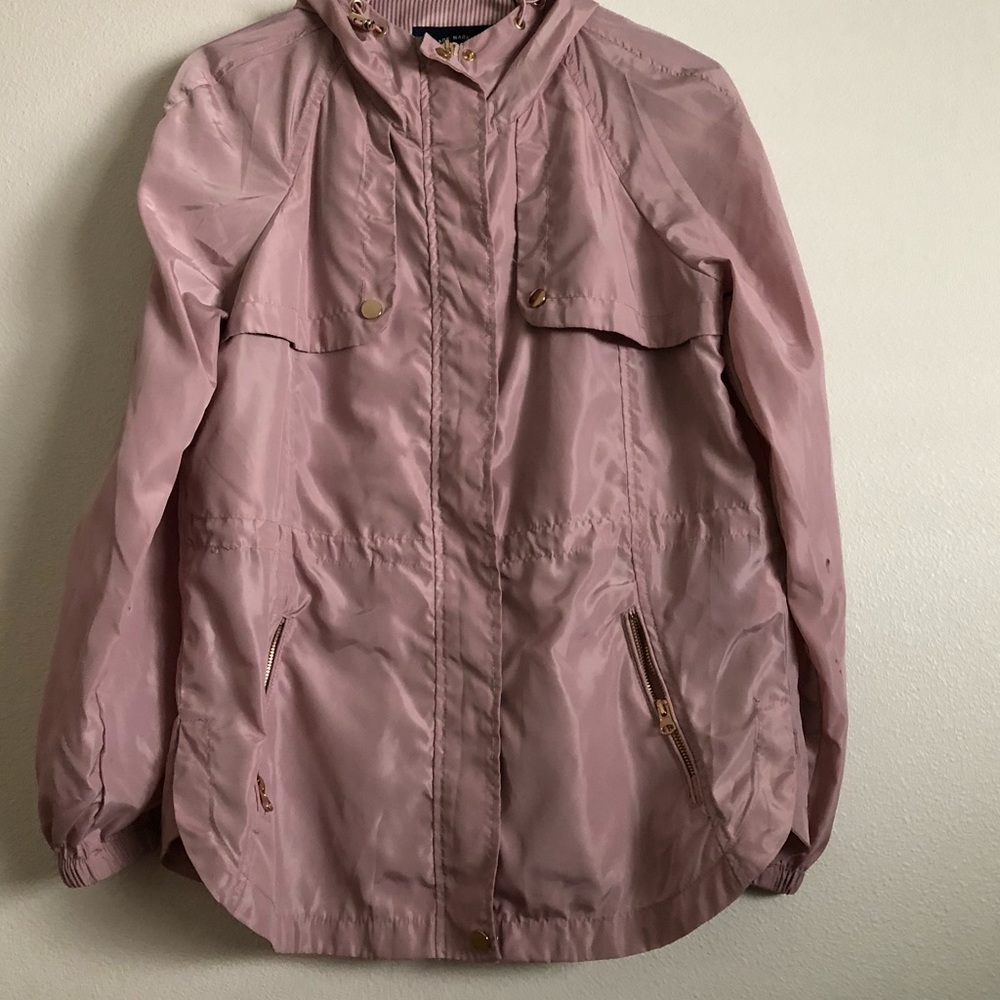 A pink raincoat, with gold zippers and buttons.